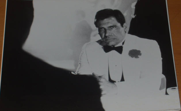 INDIANA JONES AND THE TEMPLE OF DOOM: B/W Still Indy Serious at Table