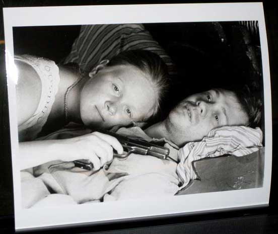 LIFE OF PRIVATE IVAN CHONKIN: Publicity Still Lying on Bed With Gun 