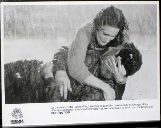 RETRIBUTION: Publicity Still Wing and Lipscomb in Rain RETRIBUTION: Publicity Still Wing and Lipscomb in Rain