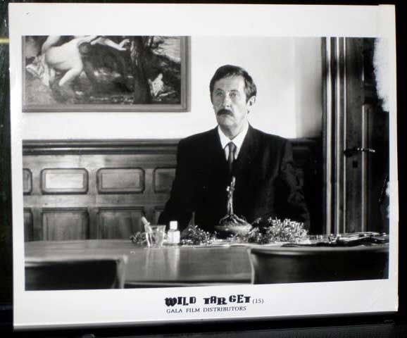 WILD TARGET: Publicity Still Man Sitting At Table 